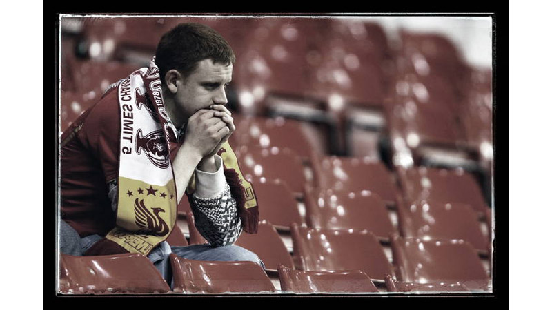 13/42 A dejected Liverpool fan, Anfield, England 2010